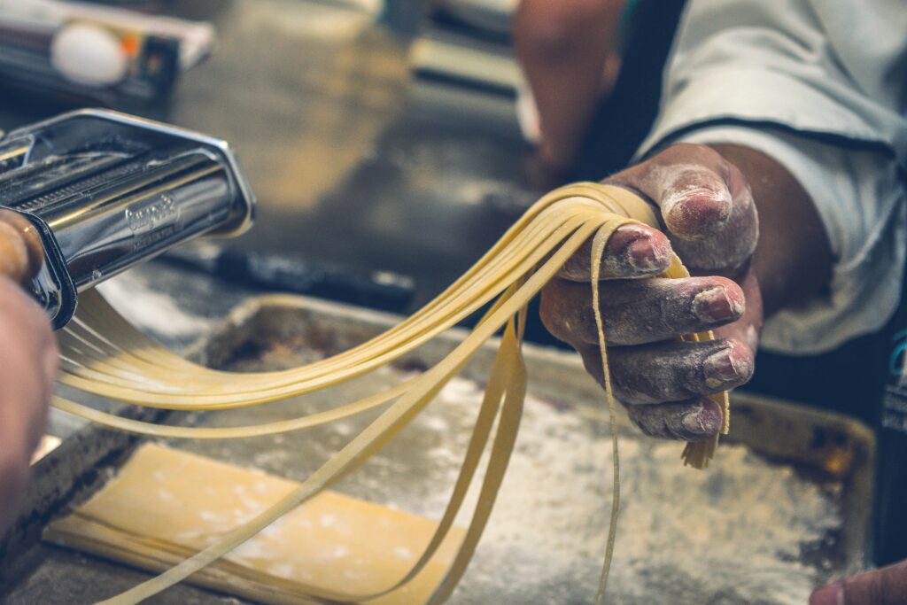 pexels-photo-1398688-1398688 Close-up of hands making fresh pasta, showcasing artisanal techniques and ingredients.