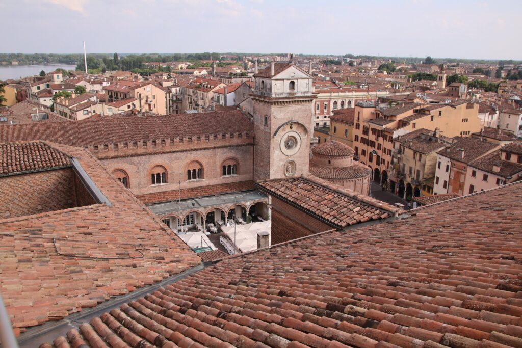 pexels-photo-32456406-32456406 Aerial view of Mantova's historic architecture, featuring a basilica amidst rustic rooftops.